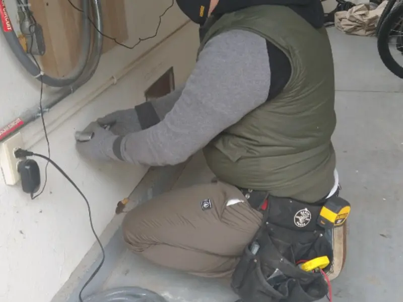 Electrician performing outlet wiring in a Glen Carbon garage